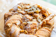 Closeup of danish almond kringle nut strudel pastry open package with macro texture on baked dessert golden crust and filling