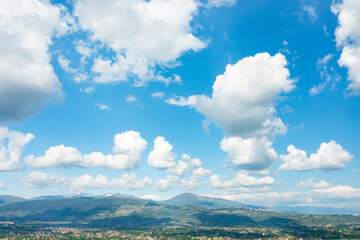 Wall Mural - Stunning view of a blue sky with some fluffy clouds. Aerial shoot, natural background with copy space.