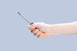 © Andrii - handyman person holding screwdriver isolated over grey background. repair service concept