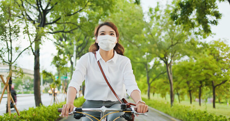 Wall Mural - Asian woman commute by bicycle