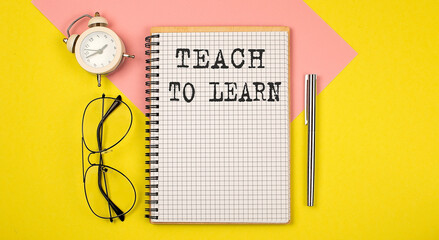 Poster - TEACH TO LEARN text on the notebook with pen on yellow background with pen, glasses and alarm cloack