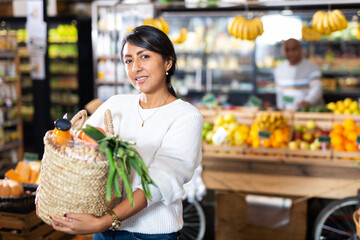 Portrait of woman with bag at grocery store