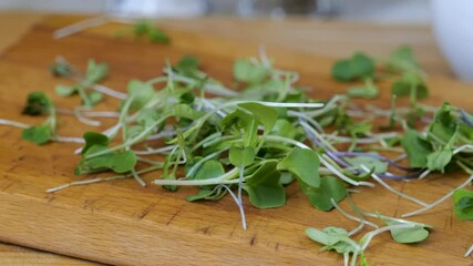 Sticker - Zooming in on micro greens falling onto a counter