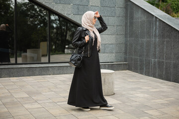 Wall Mural - modern stylish muslim woman in hijab in city street