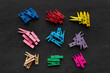 © somemeans - Clothespins of different colors are divided into groups. Sets of bright clothespins on black background.