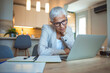 © Dragana Gordic - Cropped shot of a mature businesswoman looking stressed out while working in her office at home. Mature businesswoman having neck pain. Stressed mature woman massaging her neck.