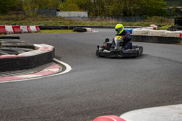 Wall Mural - A panning shot of a racing kart as it circuits a track.