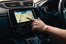 Hand Using GPS Navigation System In Car While Travel.