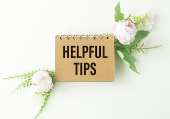 Wall Mural - Helpful tips text write on paper as background with flowers.