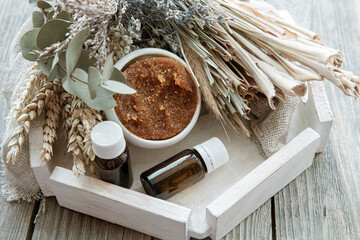 Wall Mural - Close-up of natural body scrub, oils and dry field herbs.