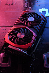 Poster - Computer game graphics card, videocard with two coolers on circuit board ,motherboard background. Close-up. With red-blue lighting