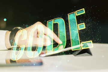 Poster - Creative Code word sign and finger clicks on a digital tablet on background, international software development concept. Multiexposure