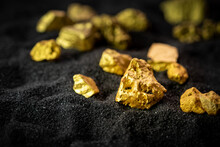 Pure Gold From The Mine That Was Unearthed Was Placed On The Black Sand.