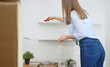 © M-Production - Woman wipes the kitchen after moving to new apartment.