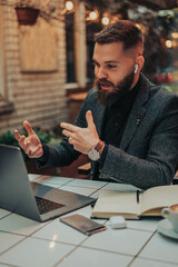 Businessman using a laptop while working remote from a cafe