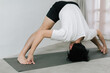 © Gengwit - Asian young man doing yoga at home