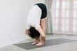 © Gengwit - Asian young man doing yoga at home