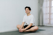 © Gengwit - Asian young man doing yoga at home