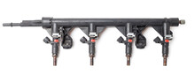 Close-up On A Car Fuel Rail With Injectors For Supplying Gasoline To A Four Cylinder Engine On A White Isolated Background. Spare Parts Catalog.