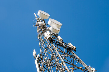 Radio, communication and cell tower on blue sky background