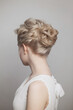 Woman blonde updo hairstyle on white background