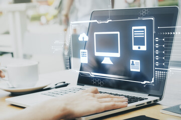 Poster - Hologram desktop with different icons in it and hands on the laptop in the background. Big data and technology concept