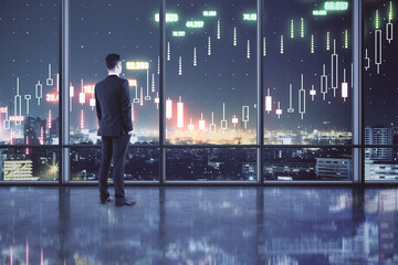 Aufkleber - Profitable investing concept with buisnessman in spacious hall looking at night city and digital screen with financial chart candlestick. Double exposure.