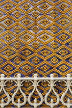 Wall Detail With Blue And Yellow Diamond Pattern And Balustrade.