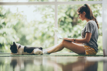 young girl playing a dog at home, cute woman person with her pet animal living from home, female are happy in lifestyle to relaxation to playing with puppy dog, stay home animal lover concept