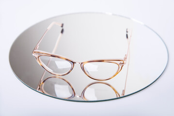  Eyeglasses on white background with mirrow reflex