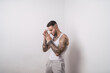 Portrait of a cool sexy tattooed Spanish male posing isolated on a white background
