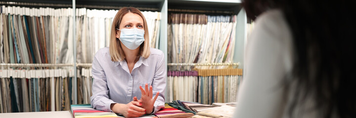 Wall Mural - Salesman in medical mask advises client closeup