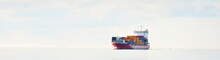 Large Cargo Container Ship Sailing In An Open Baltic Sea On A Clear Day. Freight Transportation, Nautical Vessel, Logistics, Economy, Industry, Global Communications