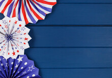 Decorations For 4th Of July Day Of American Independence, Flag, Candles, Straws, Paper Fans. USA Holiday Decorations On A Blue Background, Top View, Flat Lay	