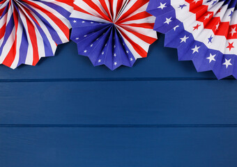 Wall Mural - Decorations for 4th of July day of American independence, flag, candles, straws, paper fans. USA holiday decorations on a blue background, top view, flat lay	