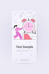 Poster - businesswoman trying to stop arrow on alarm clock effective business time management deadline concept