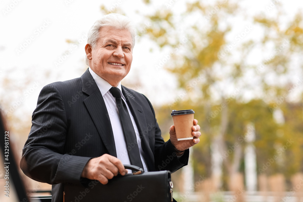 Senior businessman drinking coffee outdoors