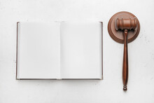 Judge's Gavel And Open Book On White Background