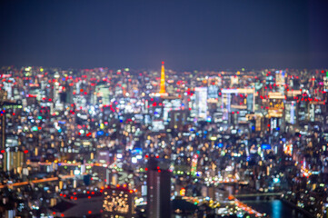 Canvas Print - Night blurred bokeh light city office building, abstract background.