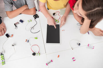Wall Mural - group of children using tablet during robotics class