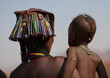 © Eric Lafforgue - Mucawana Kid In The Arms Of His Mother Wearing The Kapapo Headdress Made Of Waste Materials, Village Of Soba, Angola