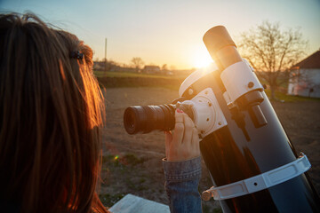 Wall Mural - woman looking at night sky with amateur astronomical telescope.