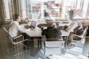 Wall Mural - Group of young business people in smart casual wear working together in office. Team at work.