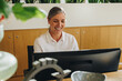 © Jacob Lund - Receptionist working on computer