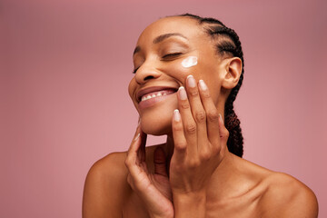 Wall Mural - Woman applying beauty product on face