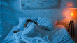© LIGHTFIELD STUDIOS - Floor lamp near woman sleeping on bed during night