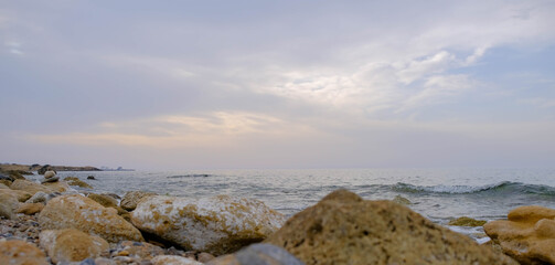 Wall Mural - Magical sunset background natural colours crashing wave Cyprus landscape beach sea stone . High quality photo