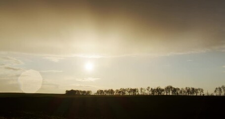 Wall Mural - Beautiful sunset on a background of trees. Timelapse of rain clouds