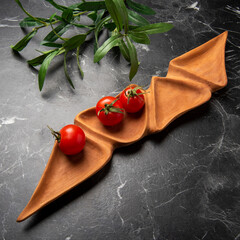 little tomatoes with wooden board