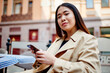 © BullRun - Thoughtful ethnic female chatting on smartphone